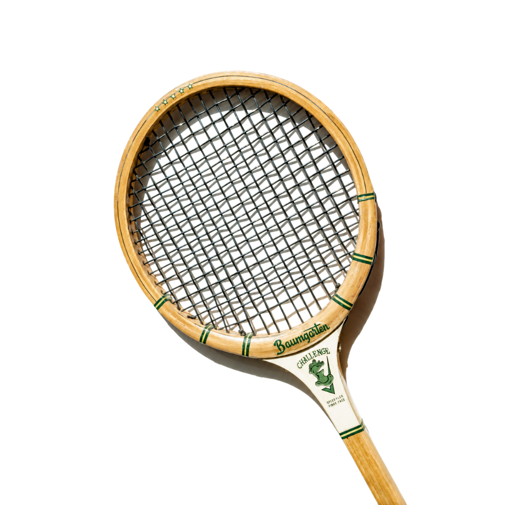 A vintage wooden tennis racket with a black mesh string pattern and green accents, labeled 'Baumgarten' and 'Challenge.'
