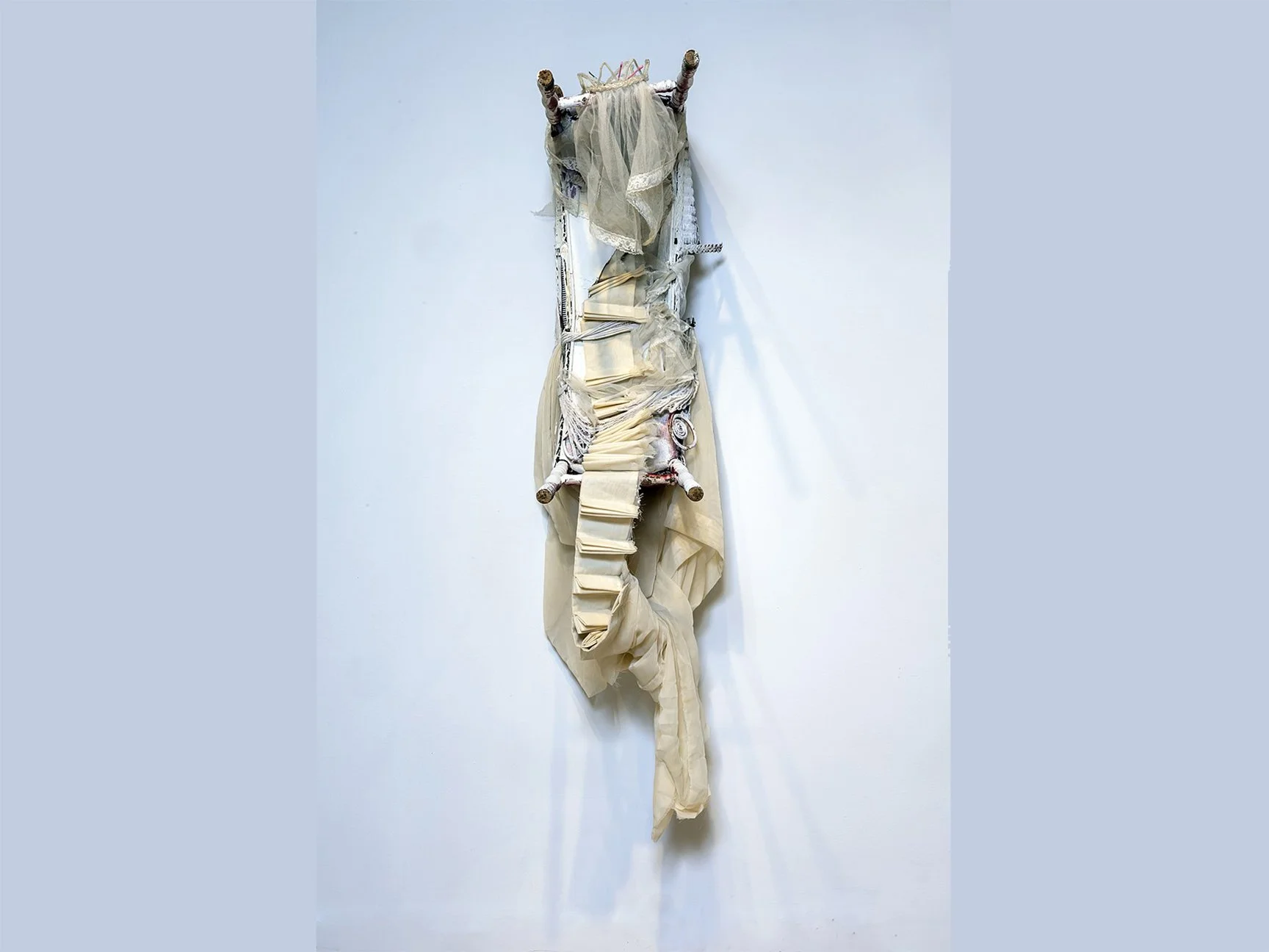 Alicia Renadette

Imprint, 2025, Modified wicker plant stand, sheer cream curtain, communion veil, leftover white ceiling paint

I gather found and foisted objects connected to childhood, comfort, and celebration from neighborhood curbside piles and 