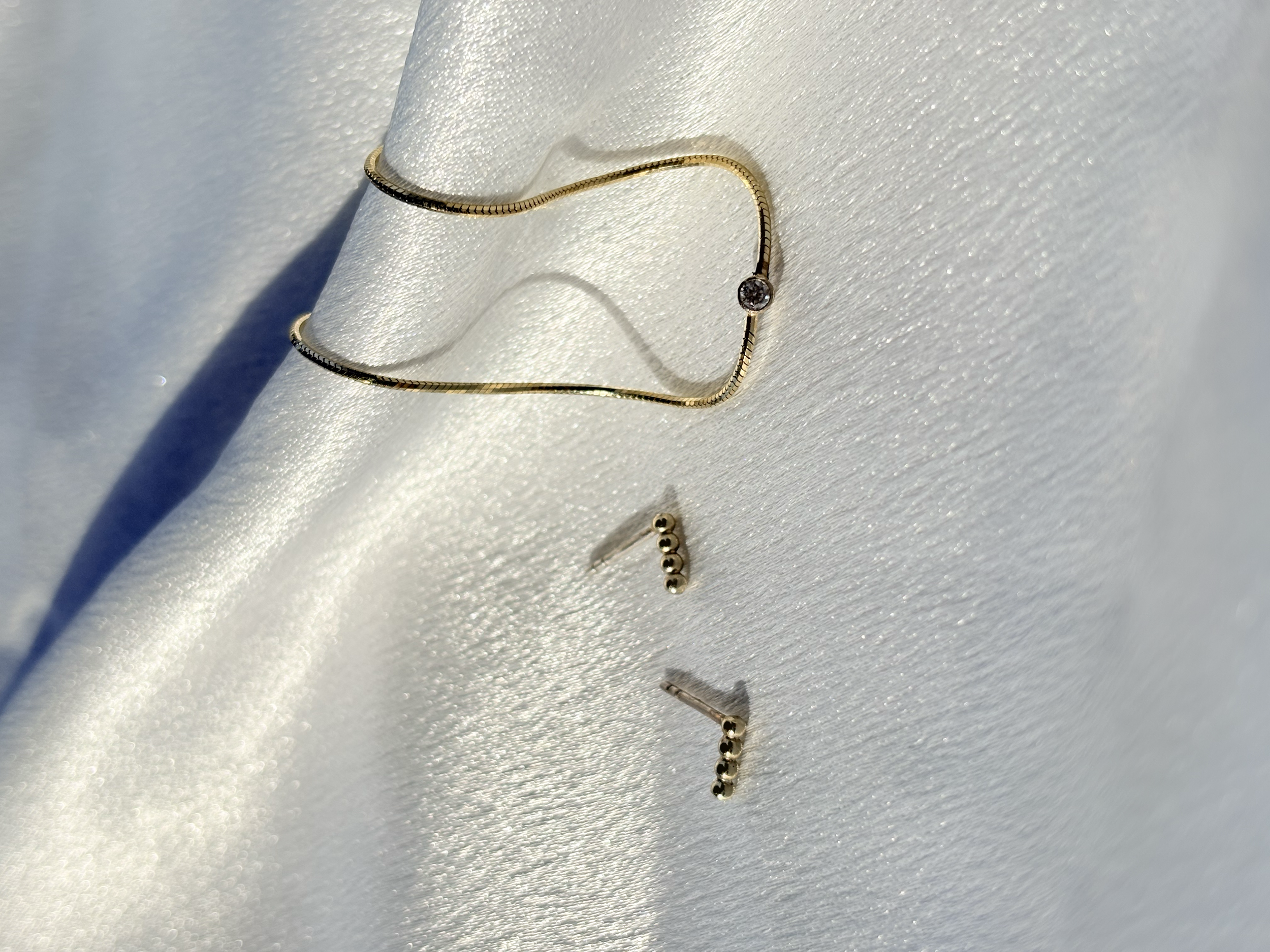 14 karaat geelgouwen armband met diamant en gouden oorbellen met zilveren steker