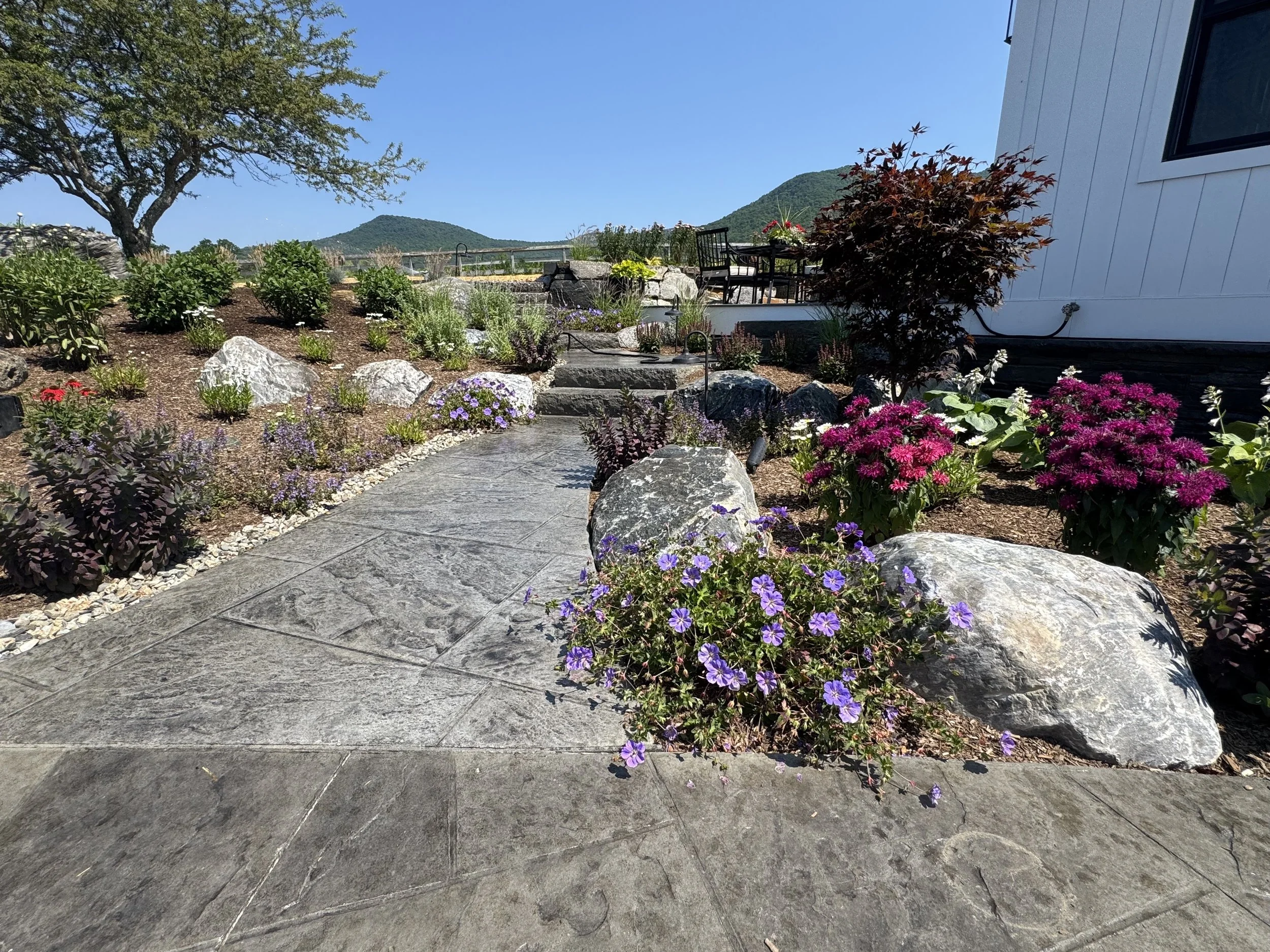 natural stone patio with steps and garden