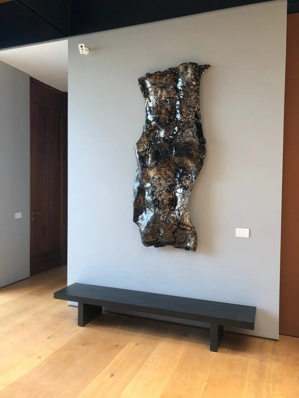 wall mounted sculpture for an entrance. Silver plated effects, bronce and smokey gray. 