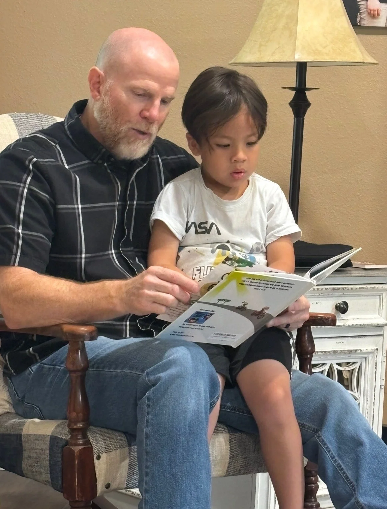grandpa reads aloud to grandson