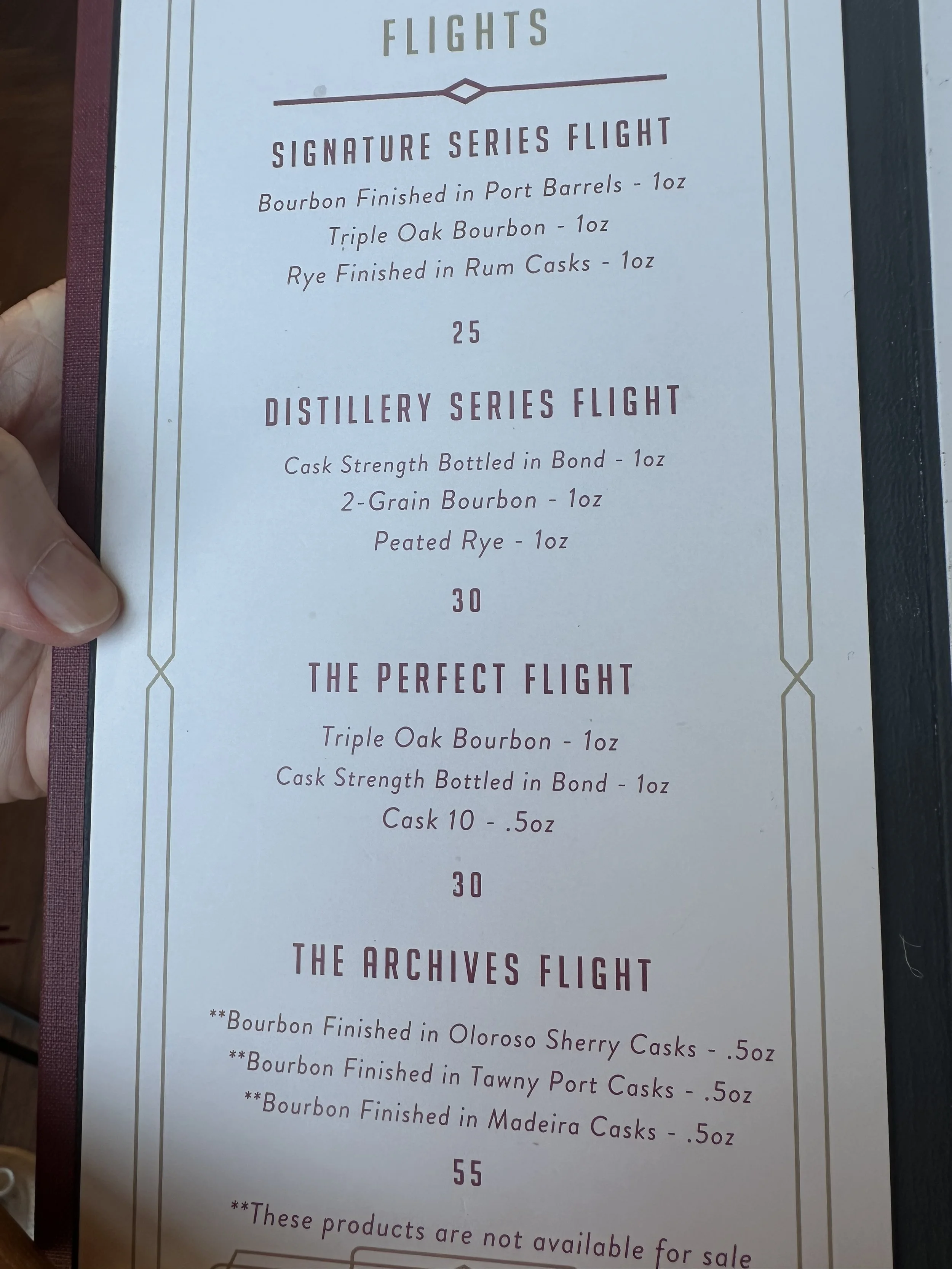 A menu listing whiskey flights, with three main options: Supplement Series Flight, Distillery Series Flight, and The Archives Flight. Each options includes different types of bourbon and rye, with prices for each flight.