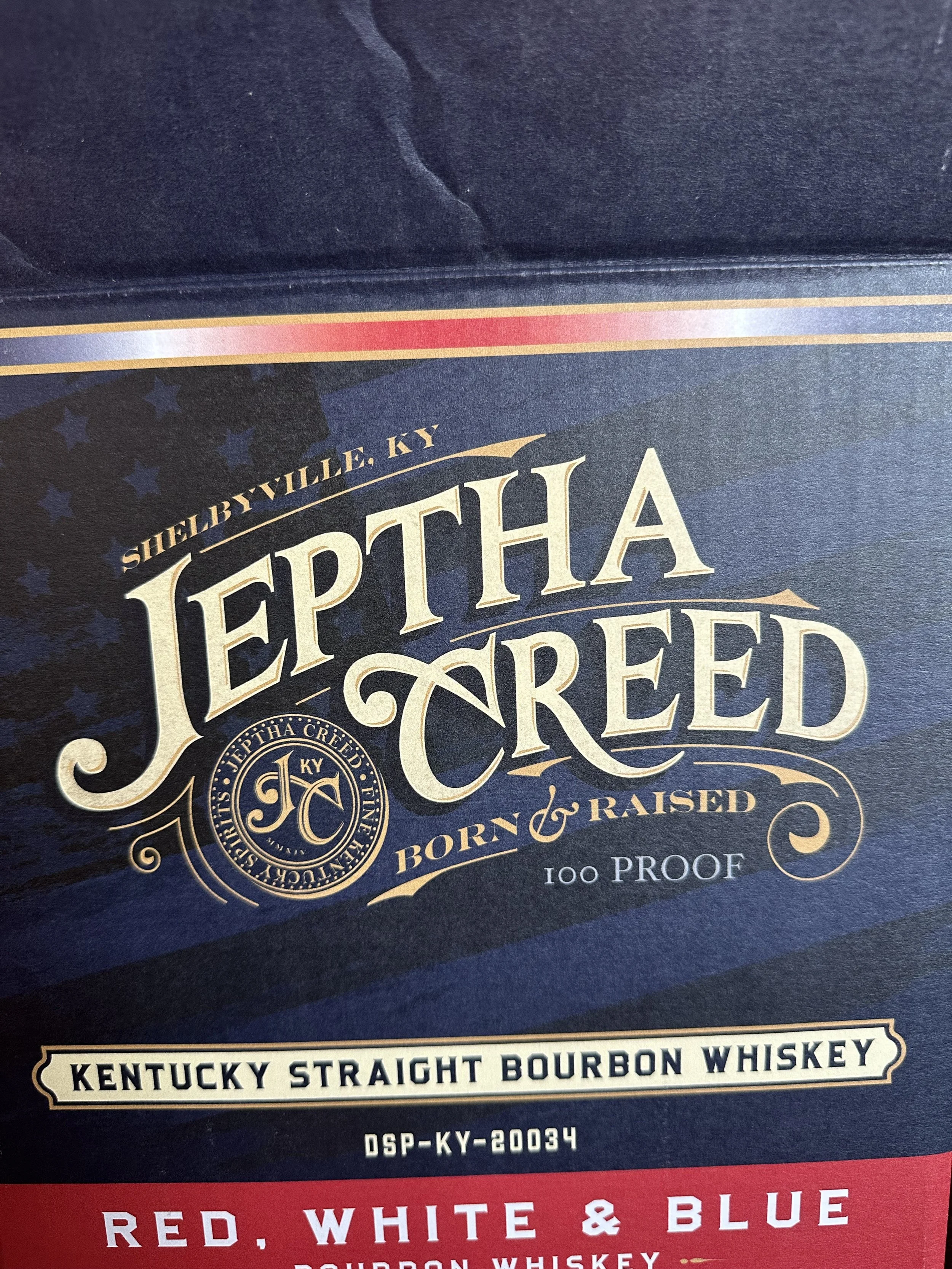 Close-up of a bourbon whiskey label featuring the brand name Jeffers Creek, located in Shelbyville, KY, with details about its proof and style.