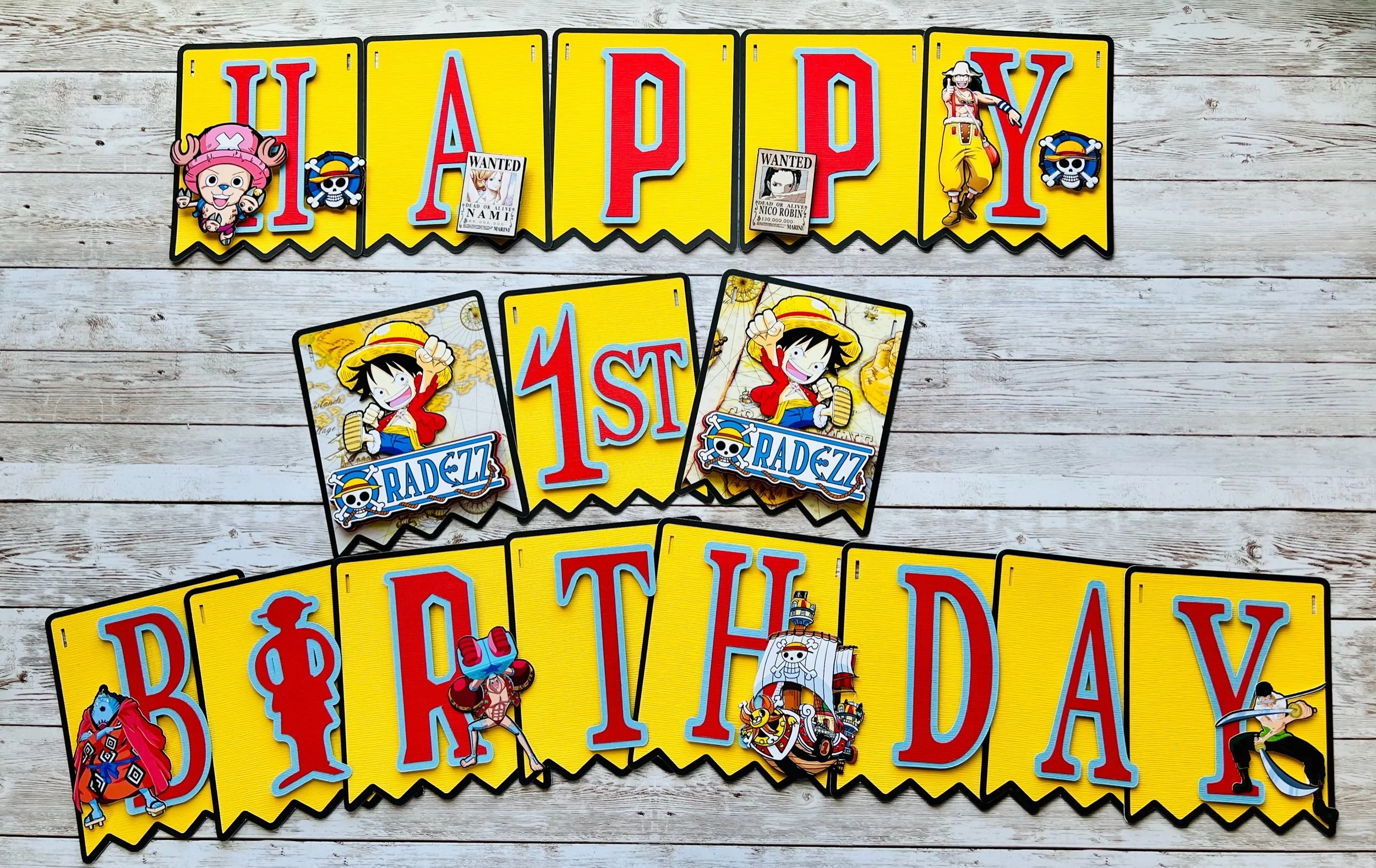 Colorful pirate-themed banner with cartoon characters, including Luffy from One Piece, and playing cards with wanted posters, on a white wooden background.