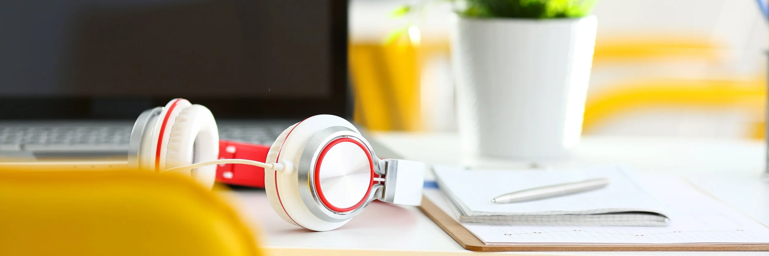 Headphones beside a notebook and calendar, representing a complimentary call to diagnose a VSCO Workspace problem.