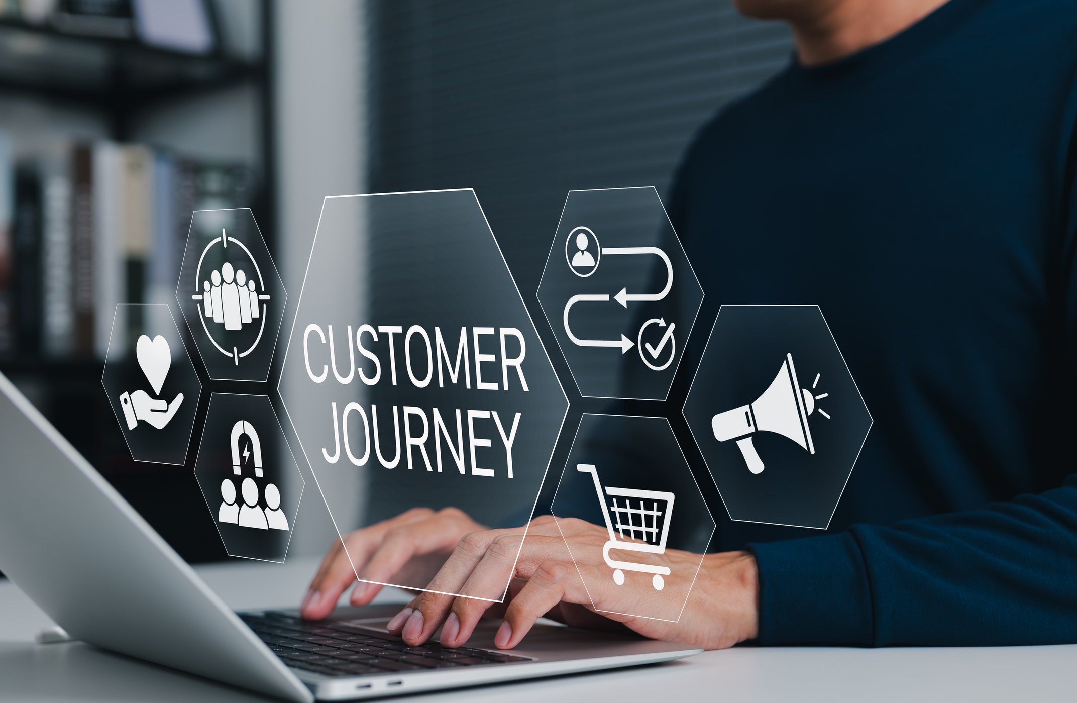 Business owner using a laptop with a customer journey diagram, representing organised and automated client emails.