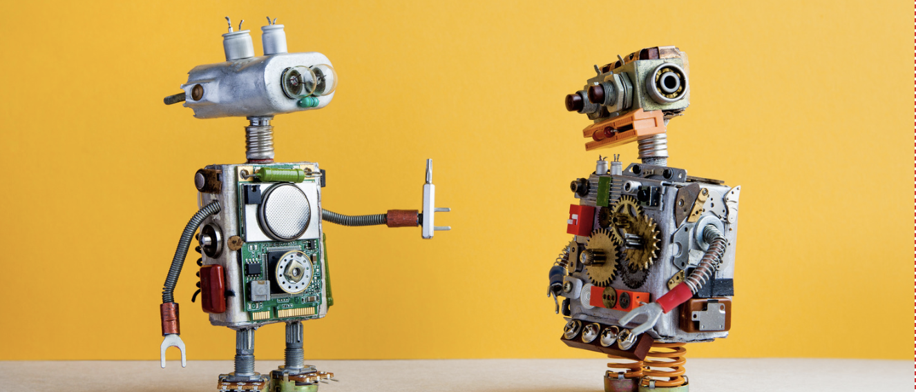 Two mechanical robots connecting, representing CRM systems and business automation working together.