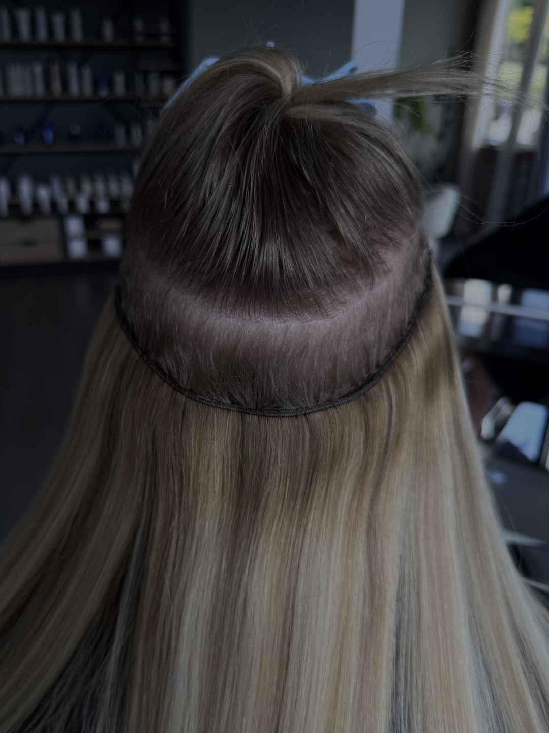 A person showcasing a healthy grow-out on her beaded row extensions.