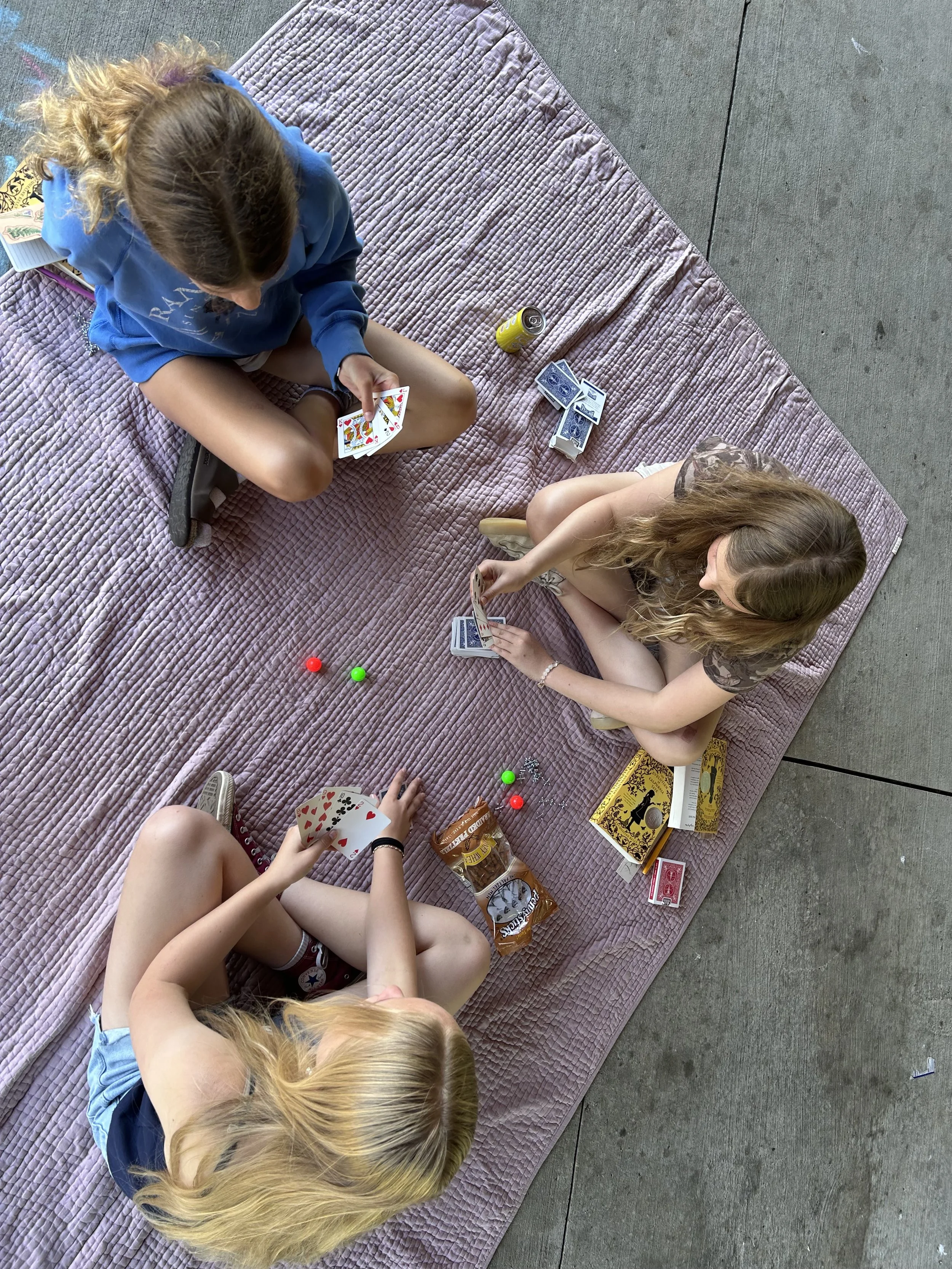 Learning new card games with new friends during Stories in Nature. 