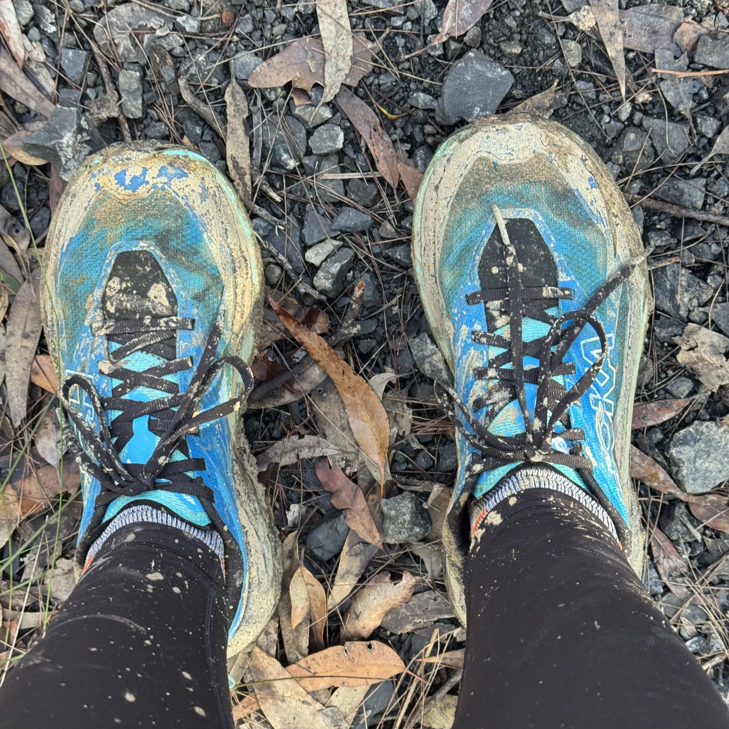 Muddy trail shoes on the fire trail after the clay descent