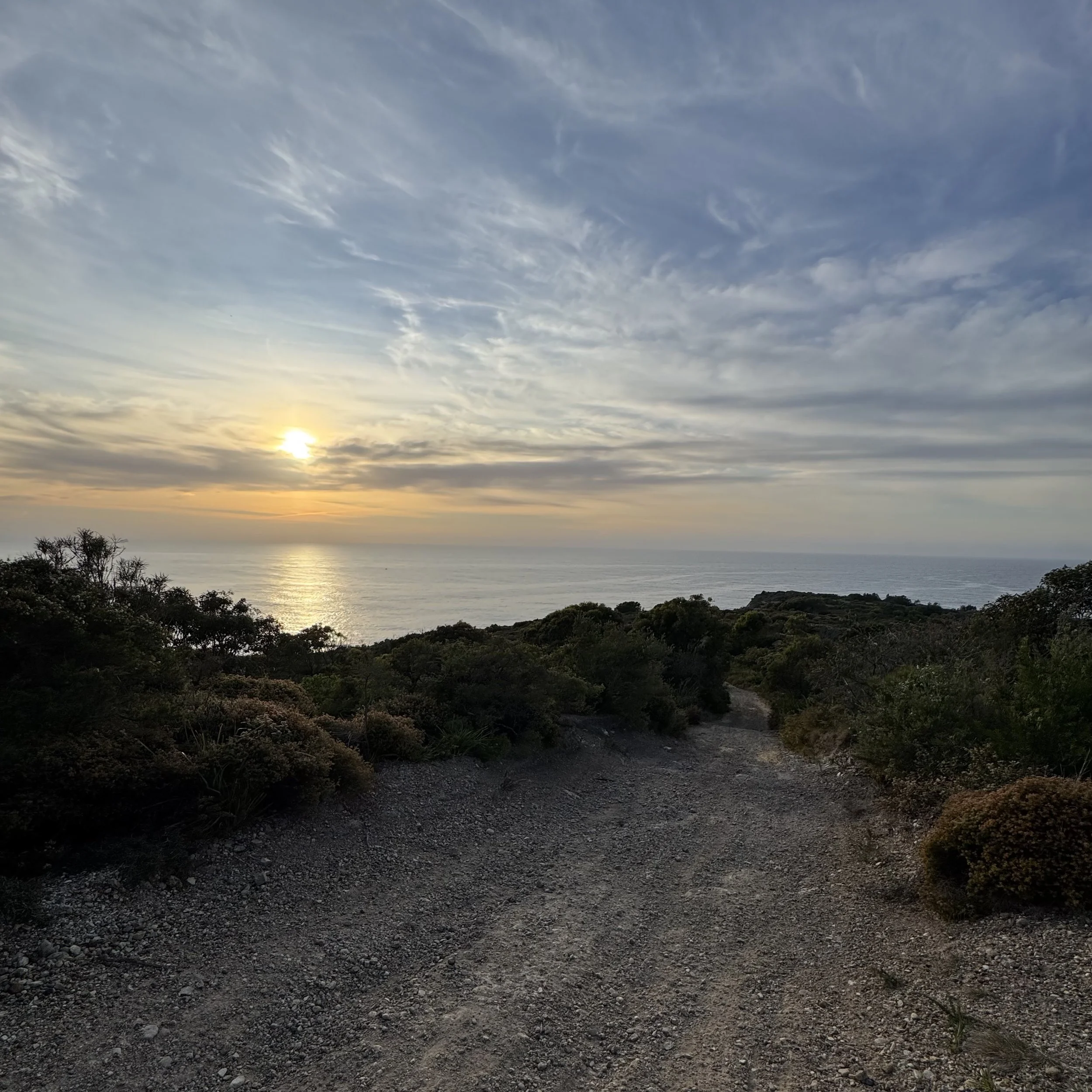 Trail above the sea at first light