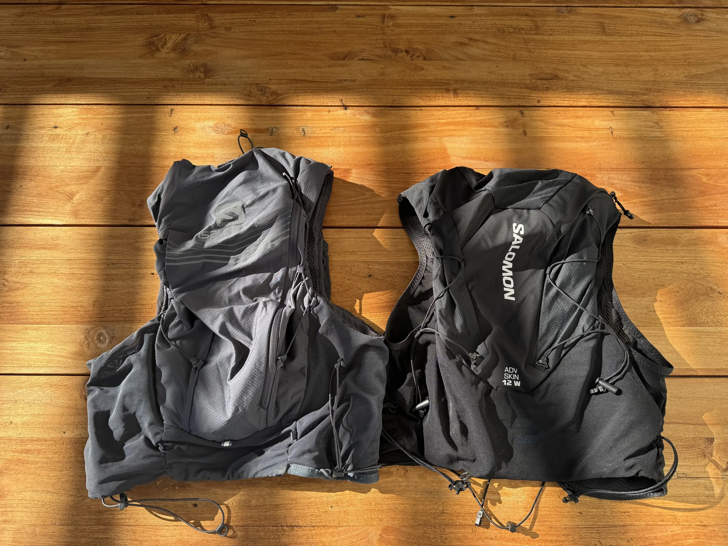 The two vests side by side, pockets and flasks