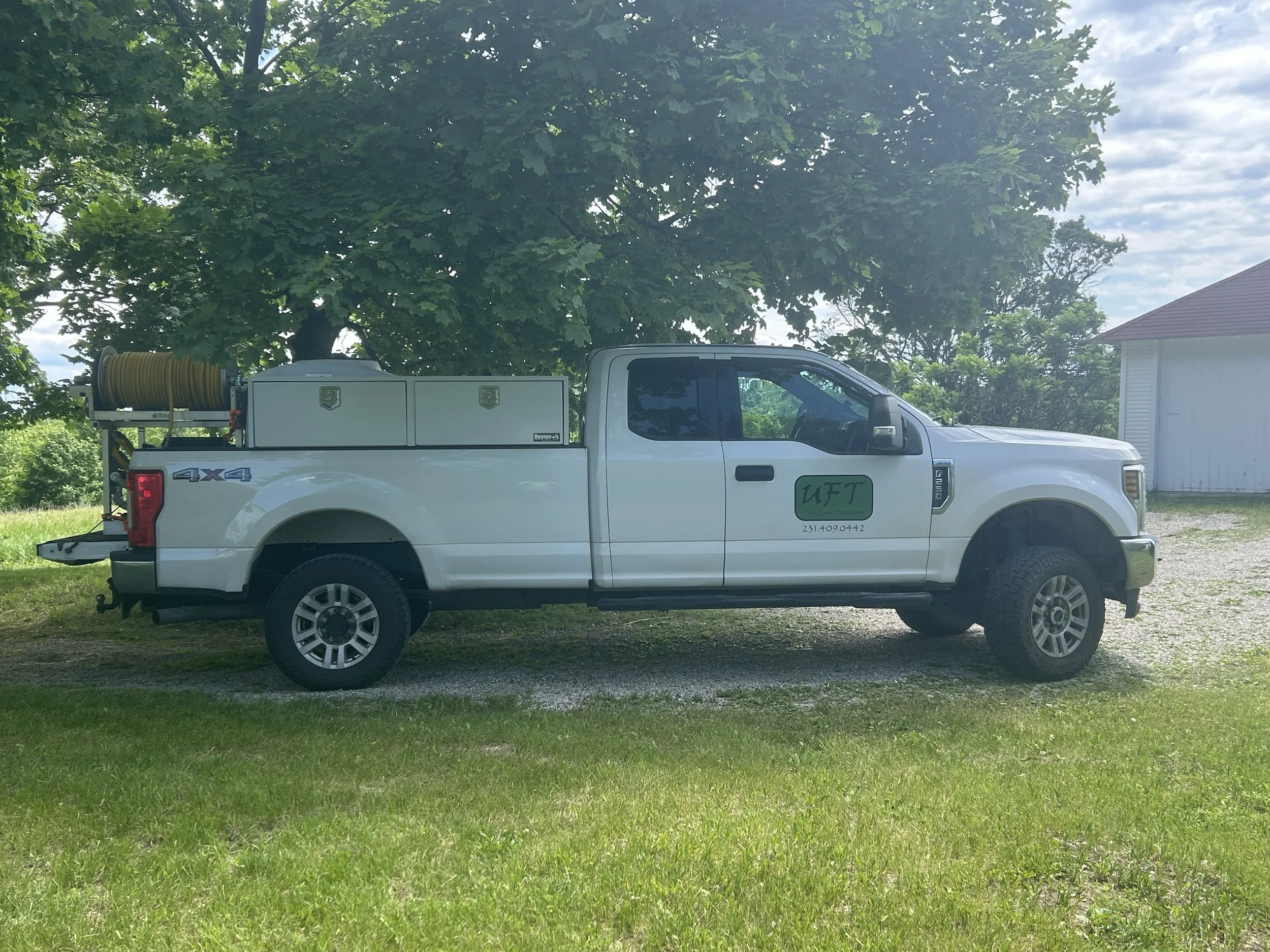 UFT Tree Care Specialists plant health care truck providing tree care services in Northern Michigan.