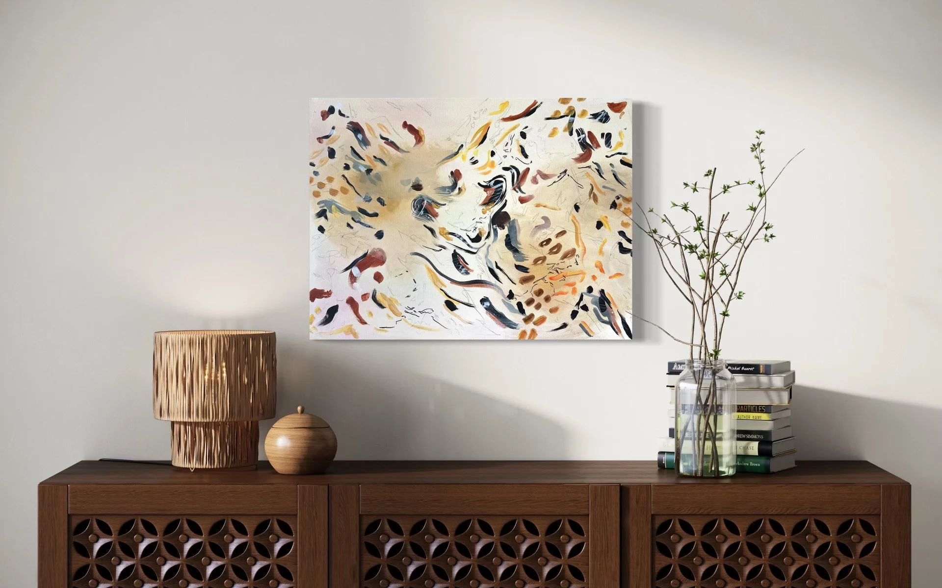 A modern interior decor scene featuring a wooden sideboard with a lattice design, topped with two decorative objects: a tall, textured beige lamp and a small wooden vase. Above the sideboard hangs an abstract painting with brushstrokes in black, brow