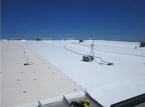 Snow-covered landscape with ski lift equipment and a clear blue sky