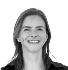 Black and white photo of a smiling woman with shoulder-length hair, wearing a collared shirt.