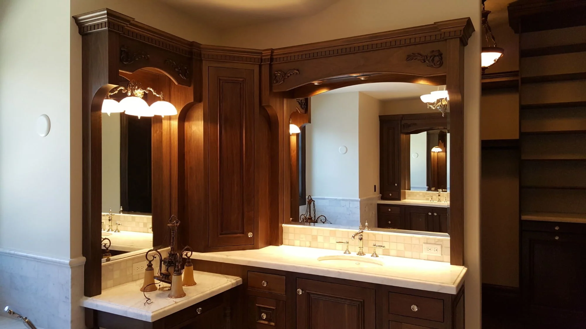 Custom bathroom with vanity lighting, wall sconces, and electrical finishes