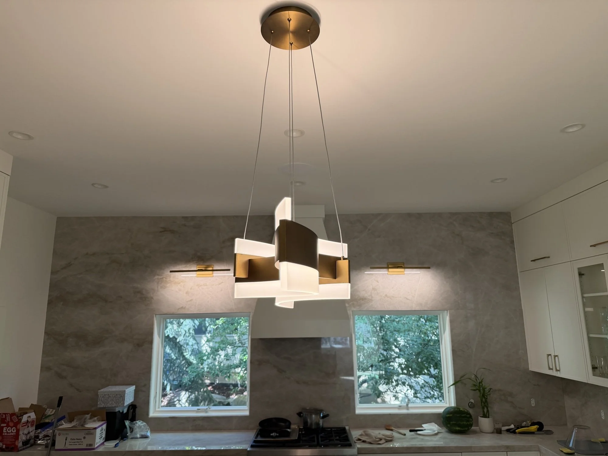 Modern pendant lights installed over a kitchen island