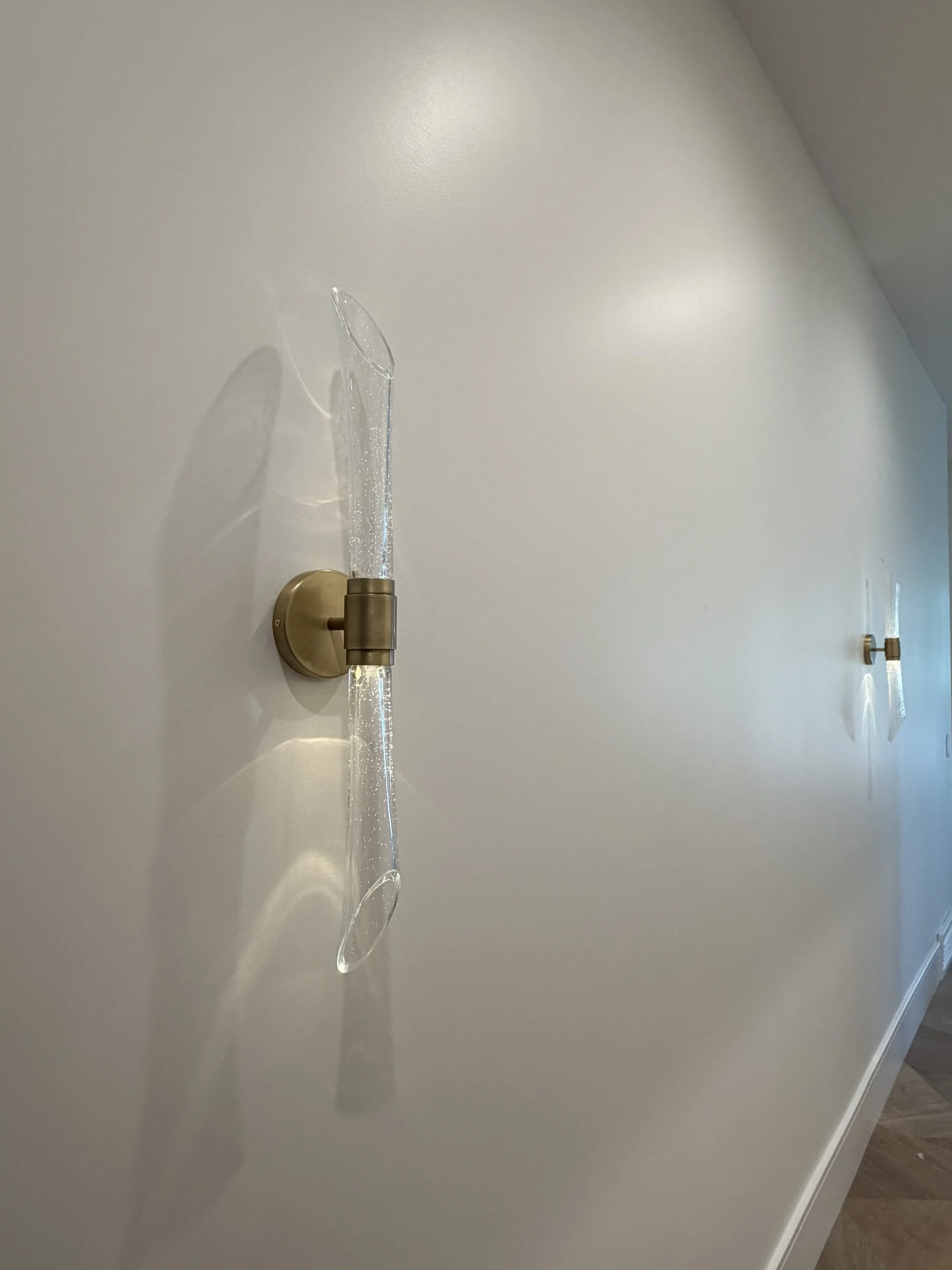 Modern wall sconce installed in a finished residential interior