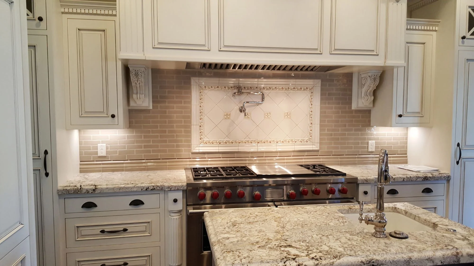 Luxury kitchen with under-cabinet lighting, recessed lighting, and decorative electrical fixtures