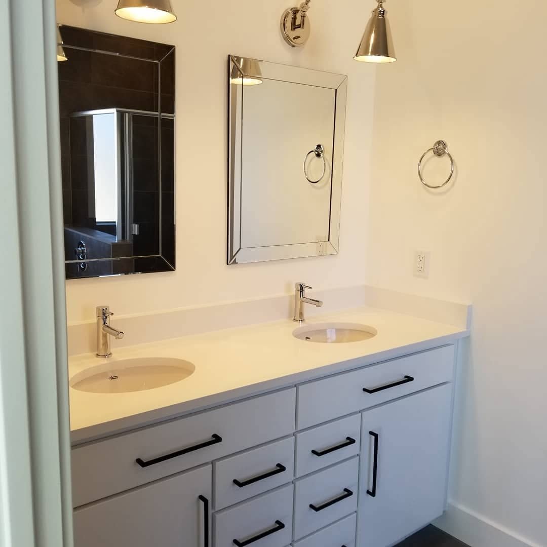 Finished bathroom with vanity lighting and electrical fixtures installed in a custom home