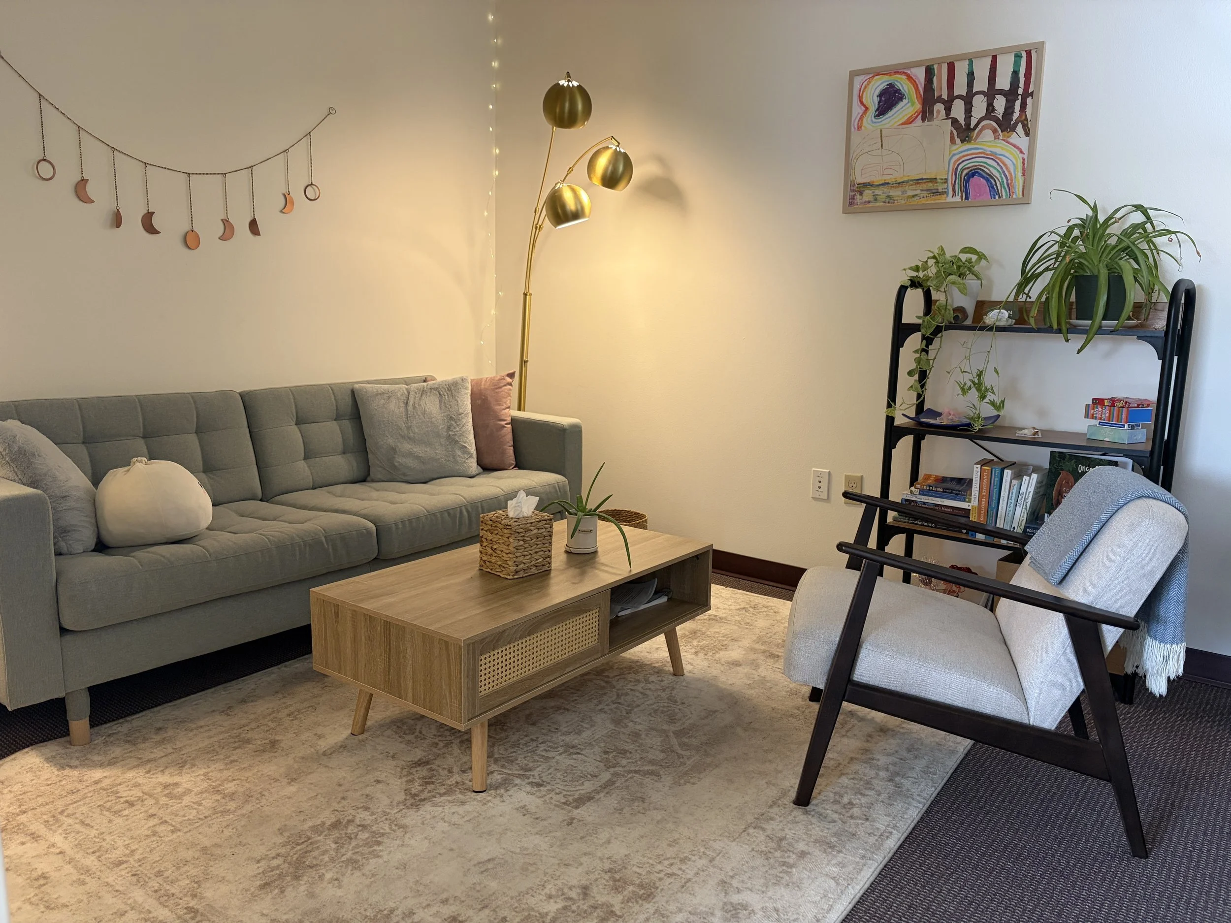 Therapy room with a sofa, coffee table and soft lighting in White Salmon, WA