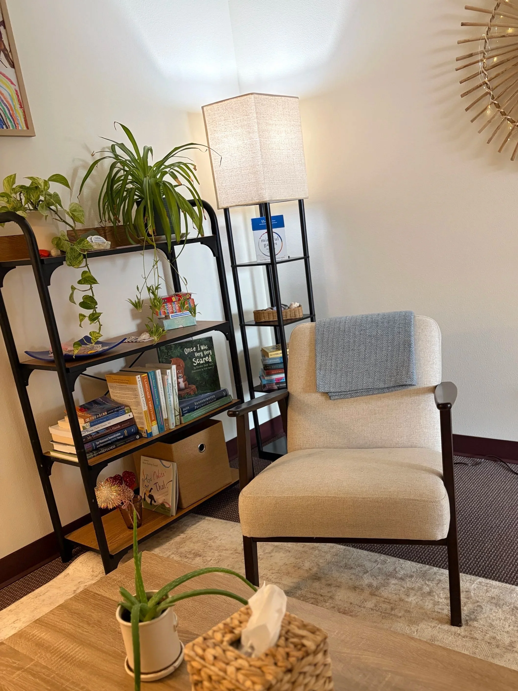 Therapy office with an armchair, plants and bookshelves at Gorge Therapy Group in White Salmon, WA