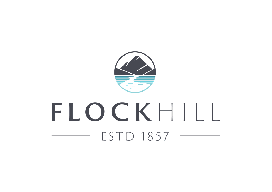 Logo for Flockhill featuring a circle with mountains, water, and a boat, along with the text 'Flockhill ESTD 1857'.