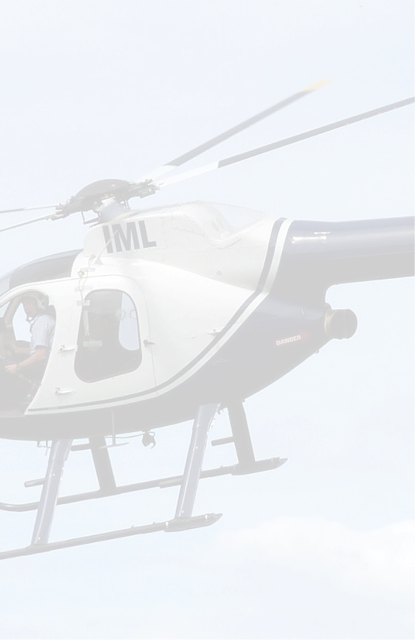 A helicopter flying in the sky with a person in the cockpit.