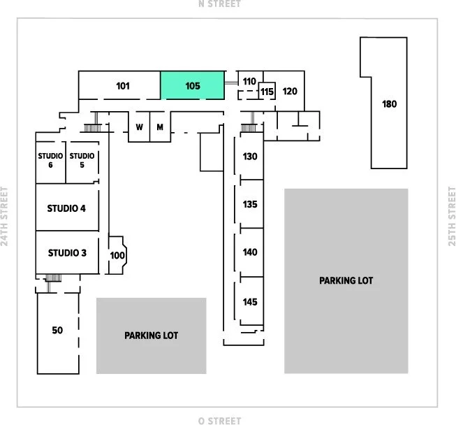 Floor plan of a building with multiple rooms labeled with numbers, including studios, offices, and storage, parking lot areas, and a section marked 105 in teal.