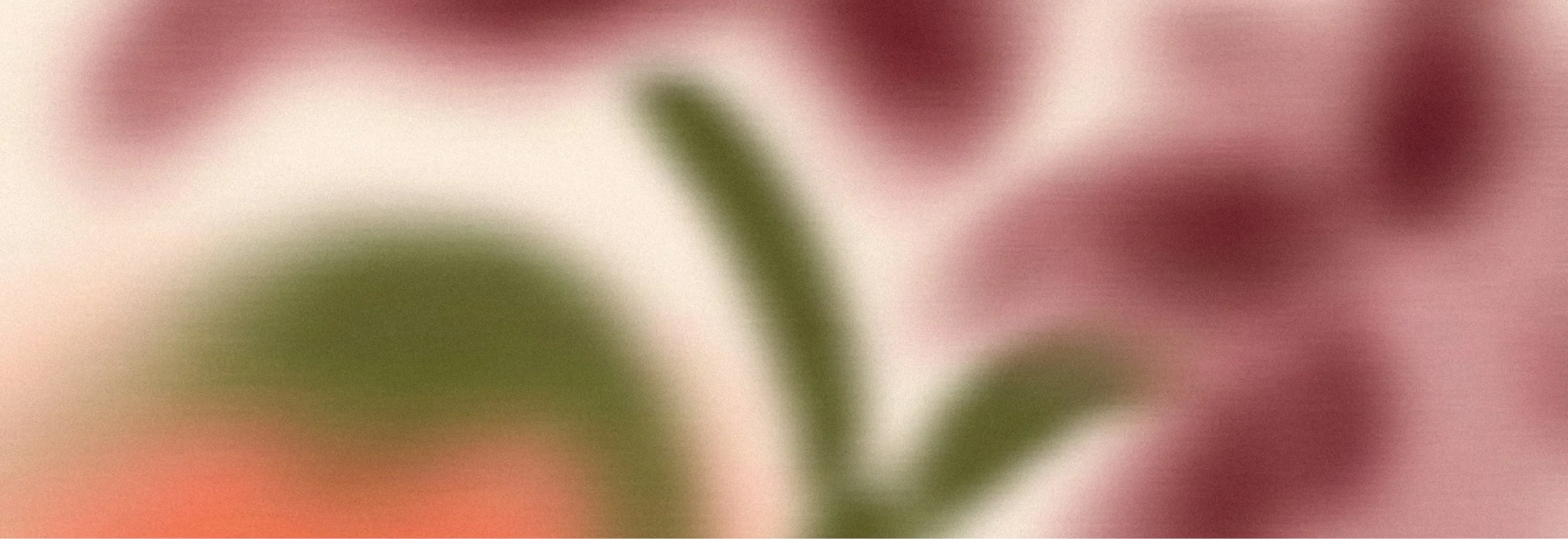 Blurred abstract image with green, pink, beige, and orange colors.