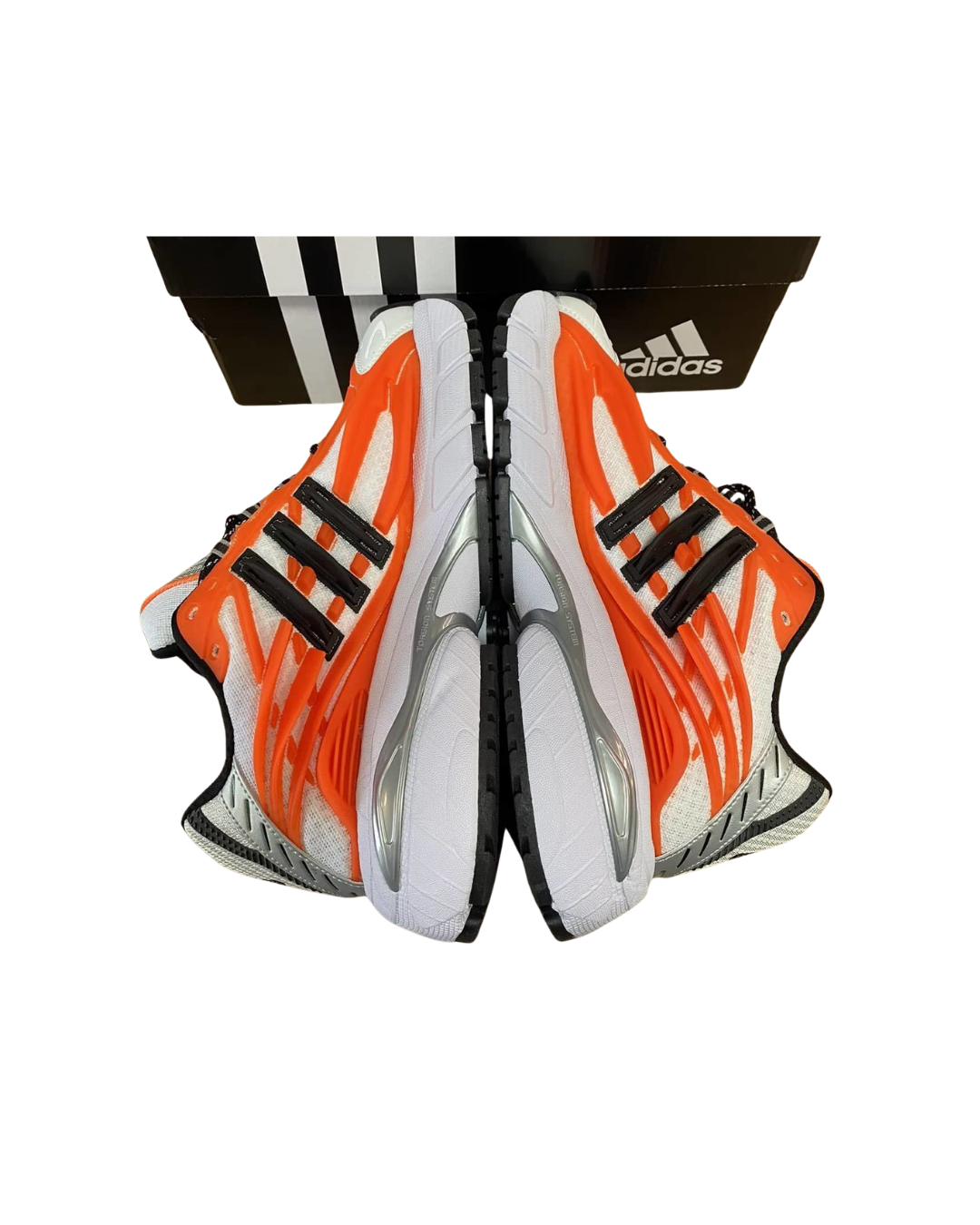 Angled top view of a pair of Pharrell x adidas Adistar Jellyfish sneakers in orange and white