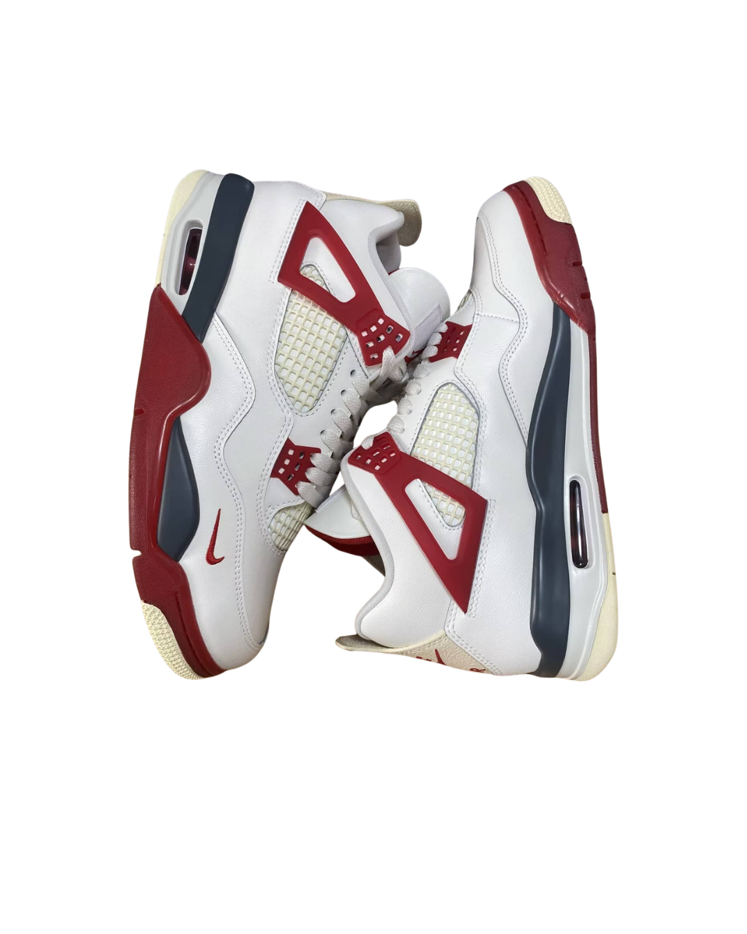 Angled three-quarter view of a pair of Nigel Sylvester x Air Jordan 4 Brick After Brick sneakers