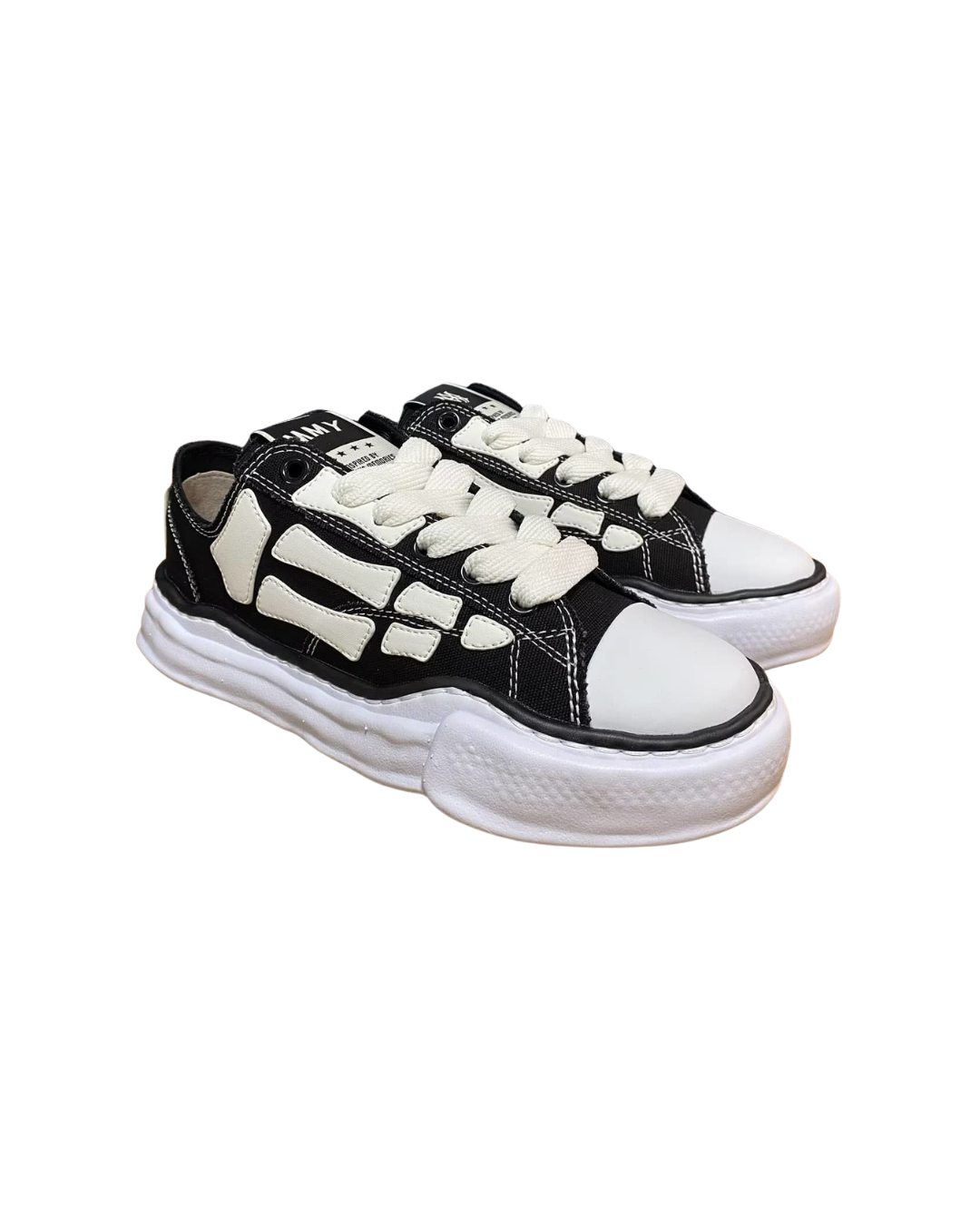 Angled three-quarter view of the AMIRI x MMY Bones sneaker in black with cream bones sole