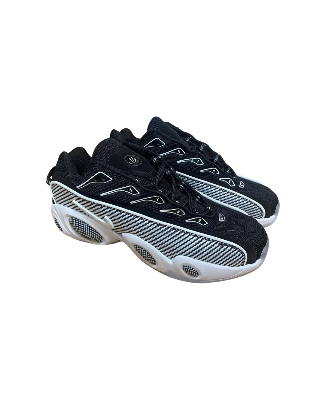 Three-quarter angled view of the Nike NOCTA Glide Drake in black and white