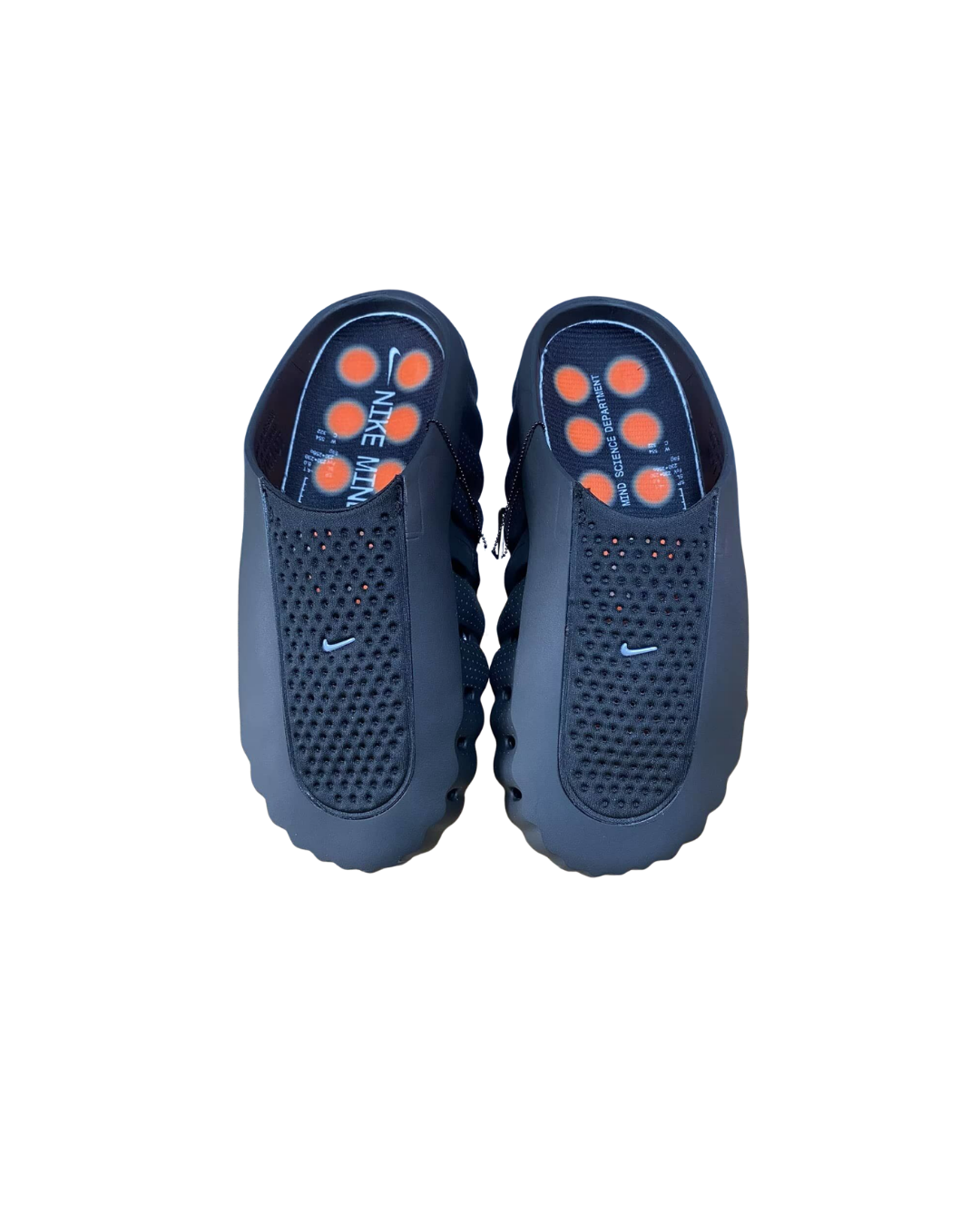 Top-down view of a pair of Nike Mind 001 black slip-on mules with orange node soles