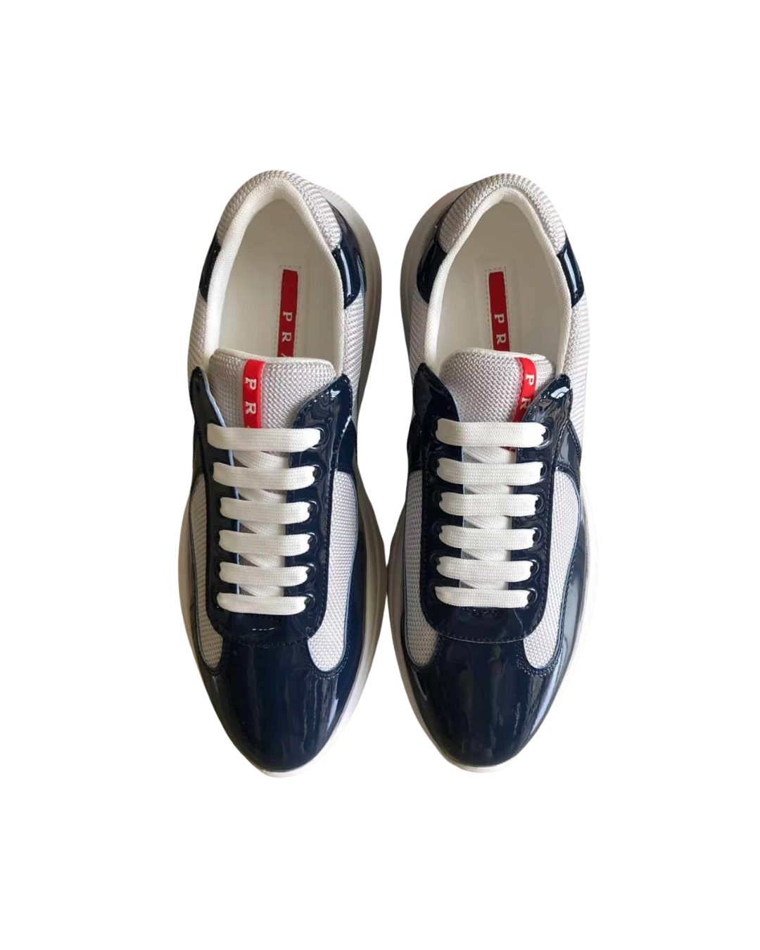Top-down view of a pair of navy Prada America's Cup sneakers with white soles