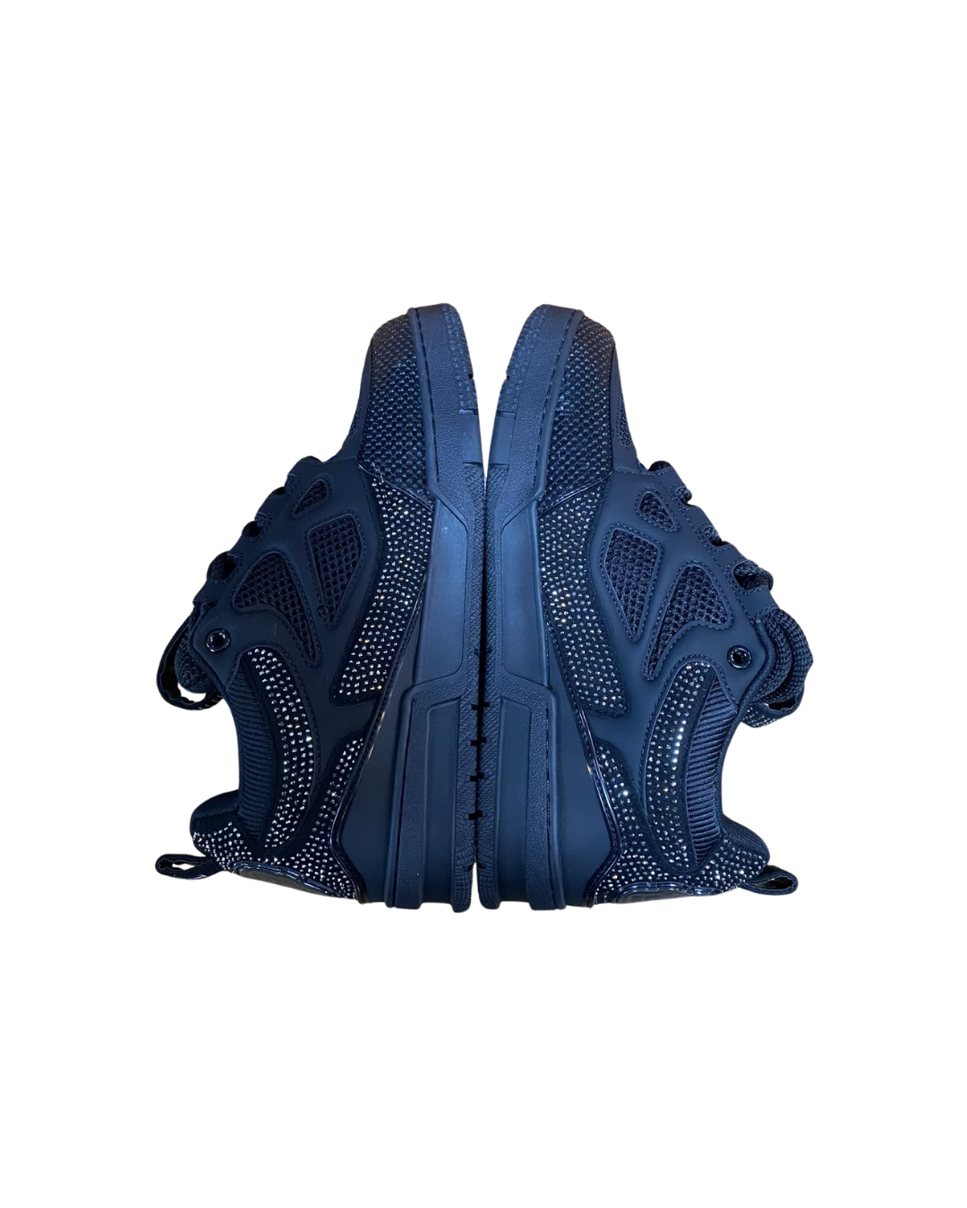 Front view of a pair of grey studded Louis Vuitton LV Skate sneakers facing each other