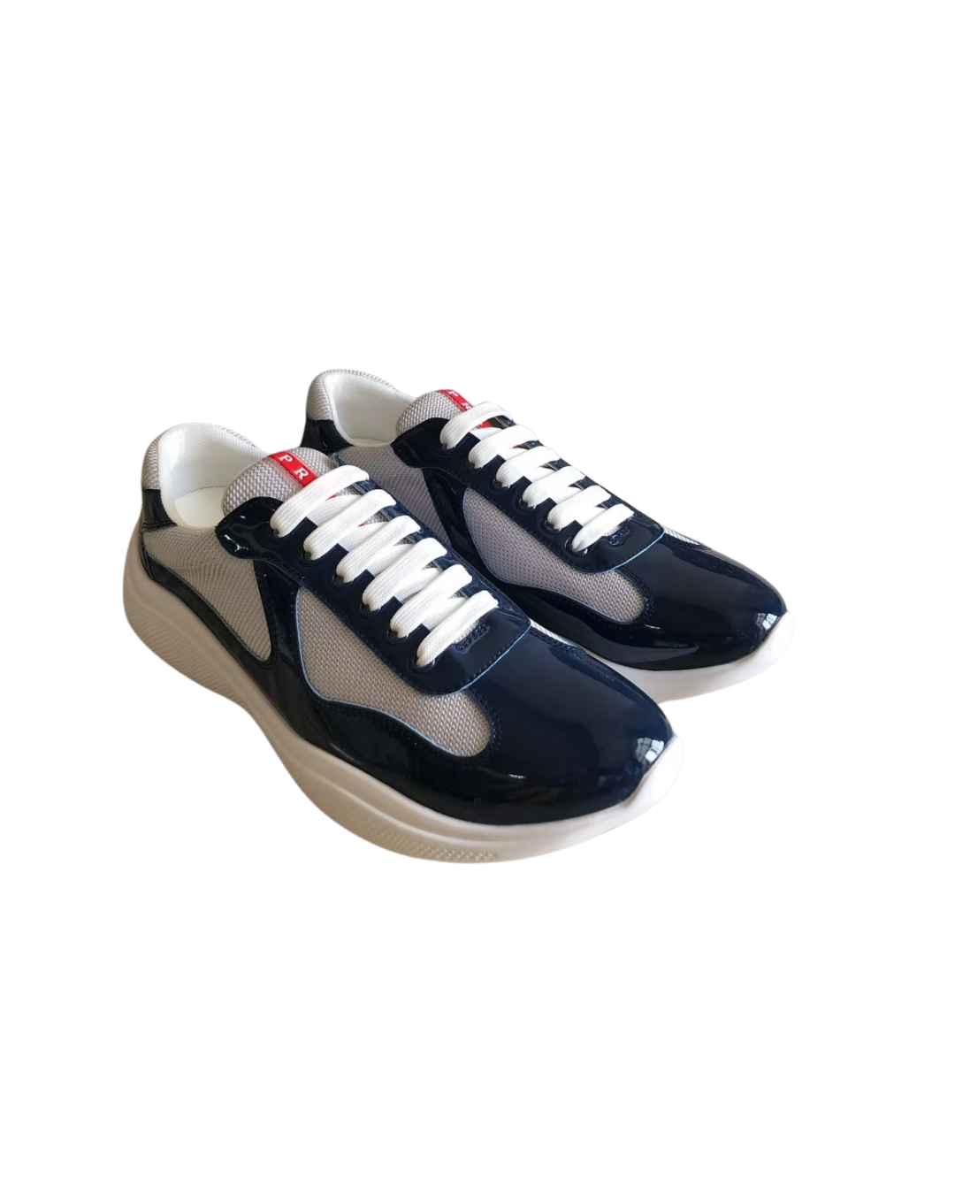 Angled three-quarter view of a pair of navy Prada America's Cup sneakers with white soles