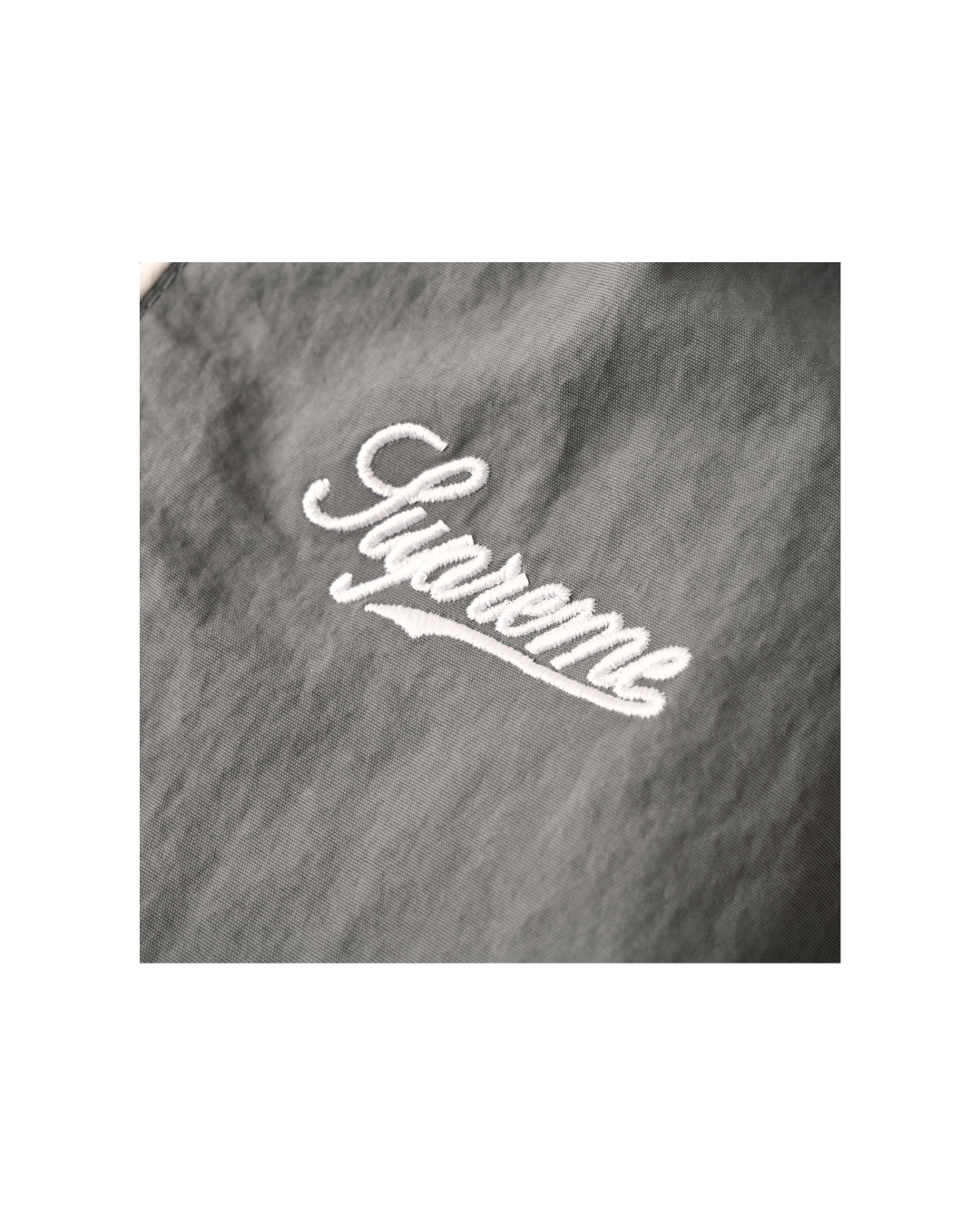 Supreme Contrast Piping Track Pant in Grey — close-up of red Supreme box logo patch
