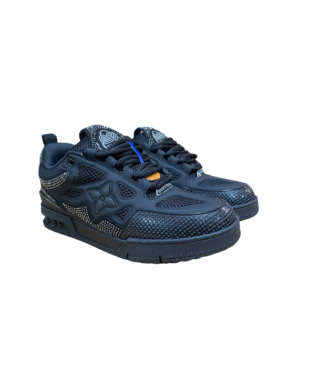Angled three-quarter view of the grey studded Louis Vuitton LV Skate sneaker