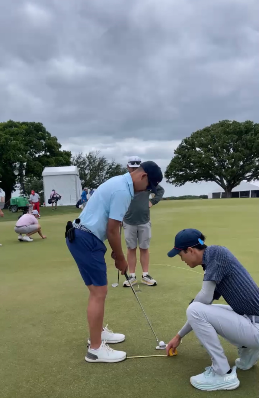 Robert Lee working with PGA Tour and Korn Ferry Tour Player Tain Lee on a putting green at Texas Rangers Golf Club during Tuesday practice rounds for the 2024 Veritex Bank Championship.