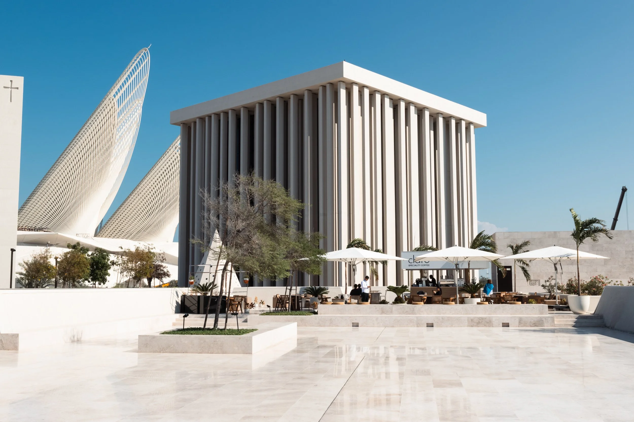 Modern & unique architectural designs set against a clear blue sky. Abrahamic Family House, Abu Dhabi, UAE.