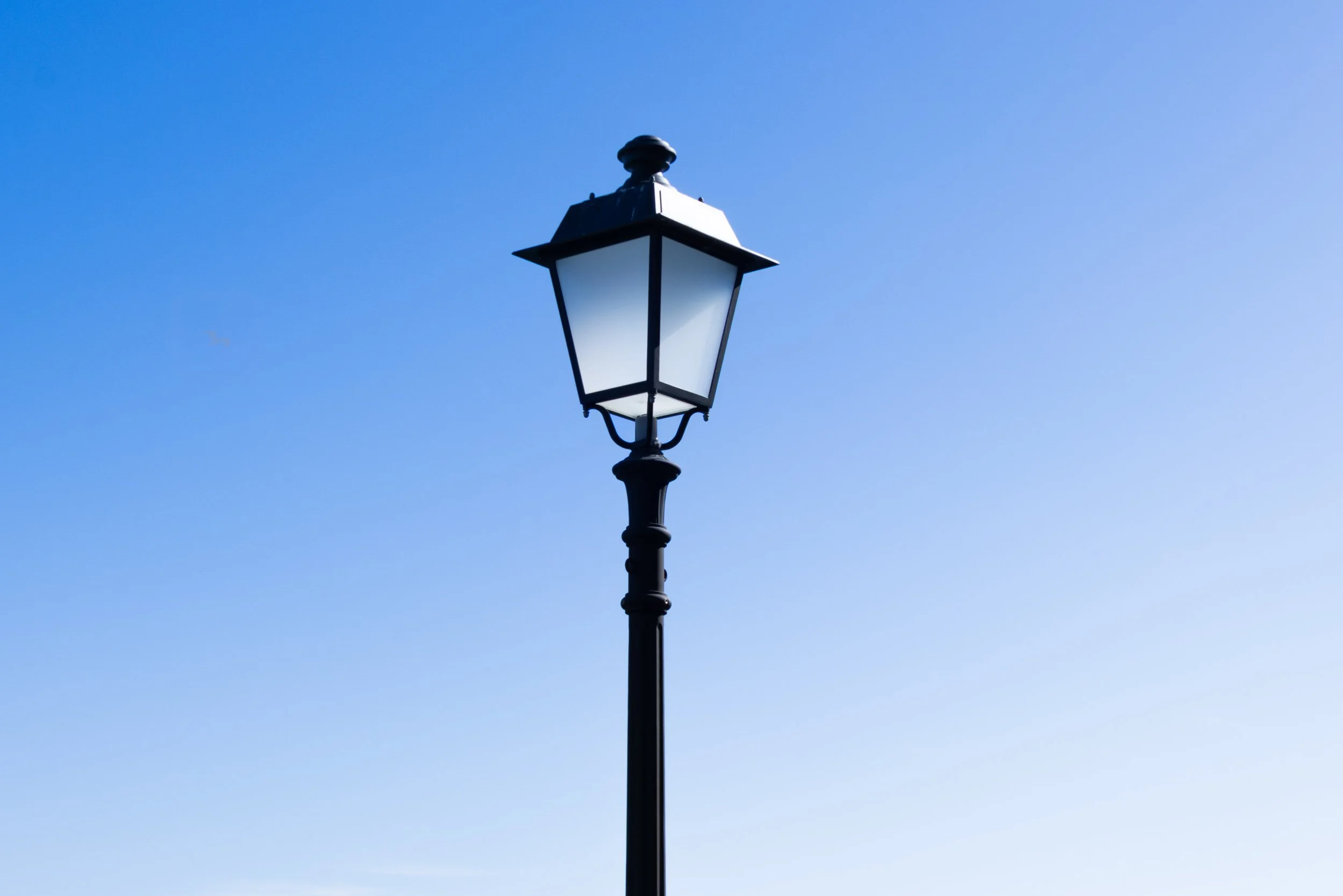 Street lamp against a clear blue sky.