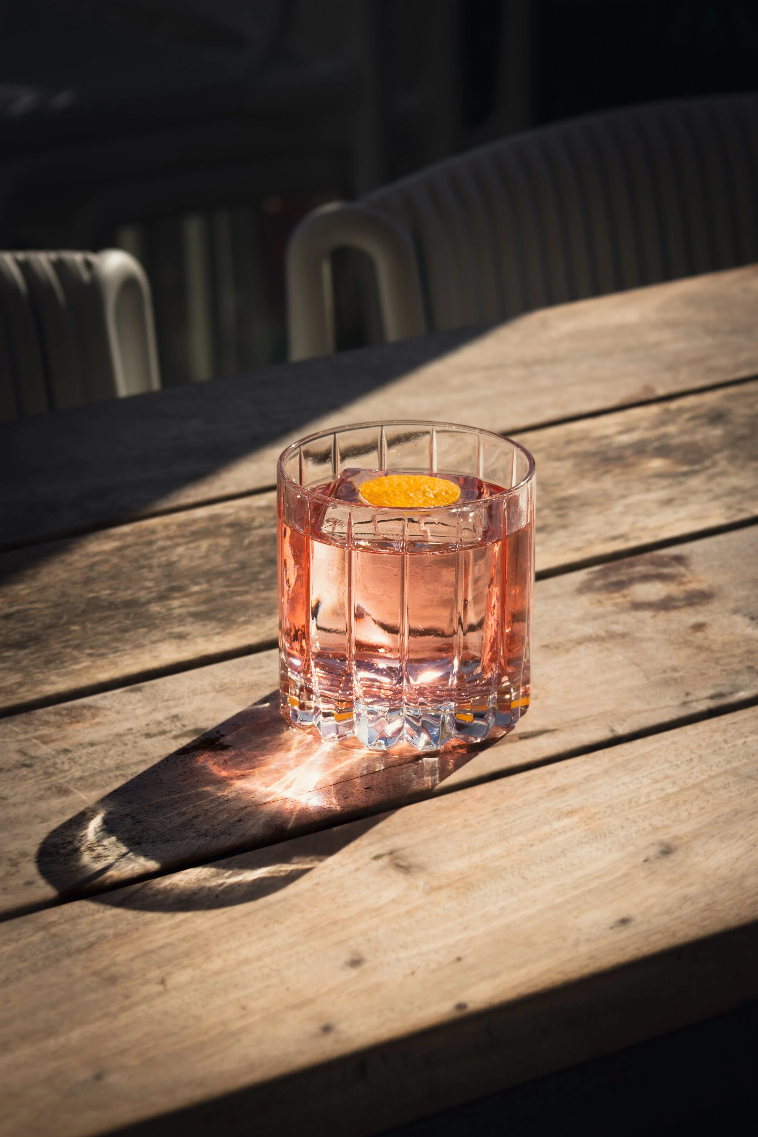A clarified Strawberry Cosmo sat in the golden hour sun.