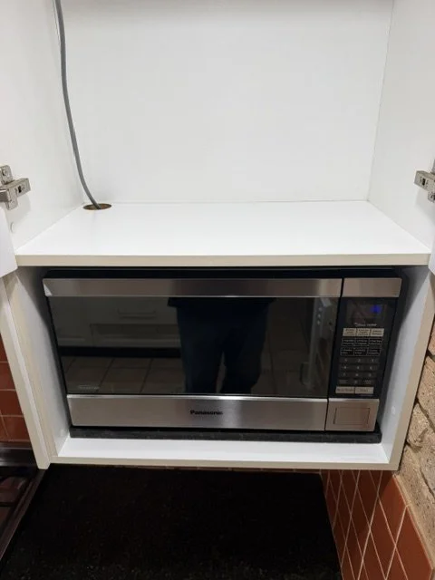 Microwave and cupboard after cleaning.