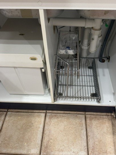 Under kitchen sink before cleaning.
