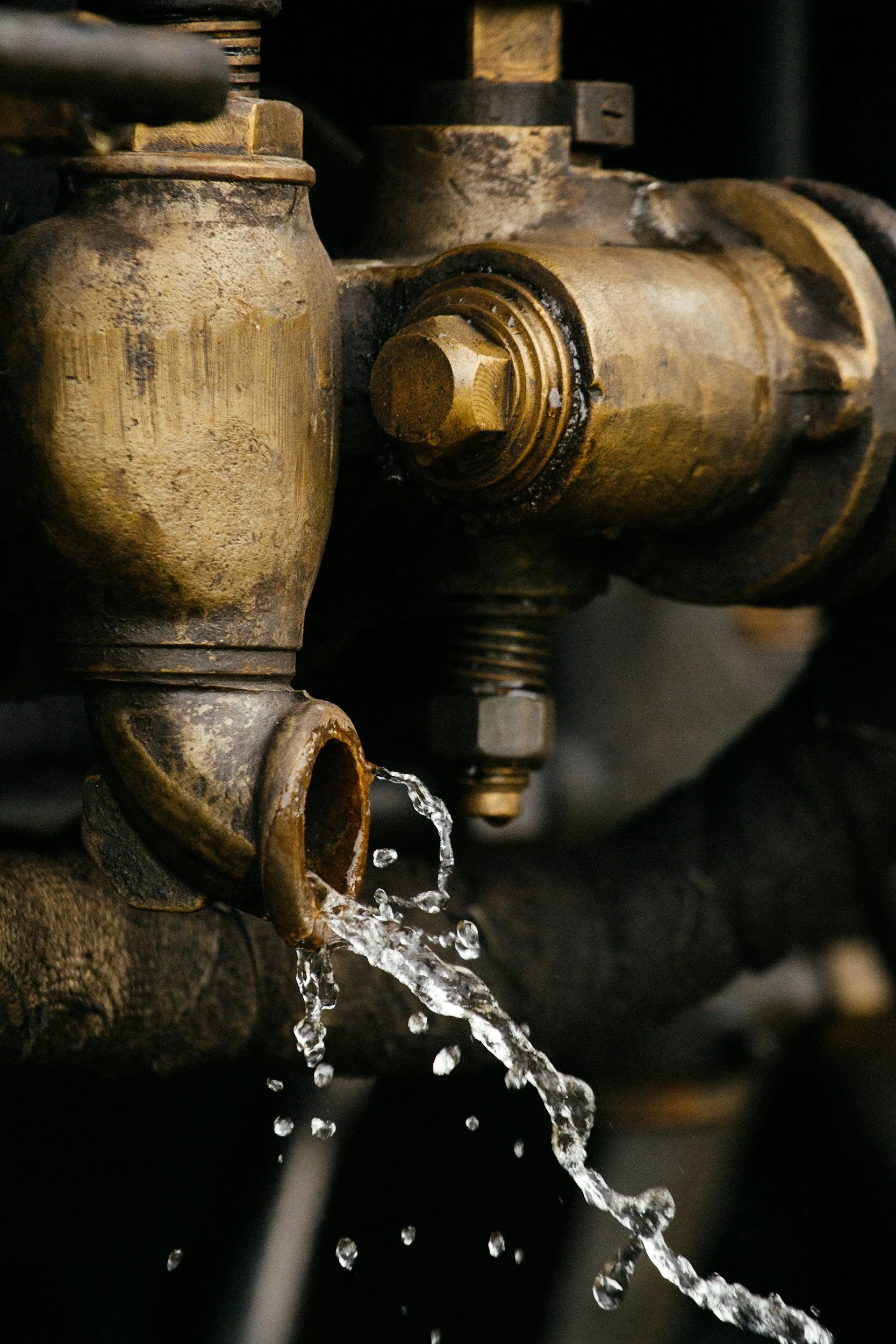 Galvanised pipe with water spilling out