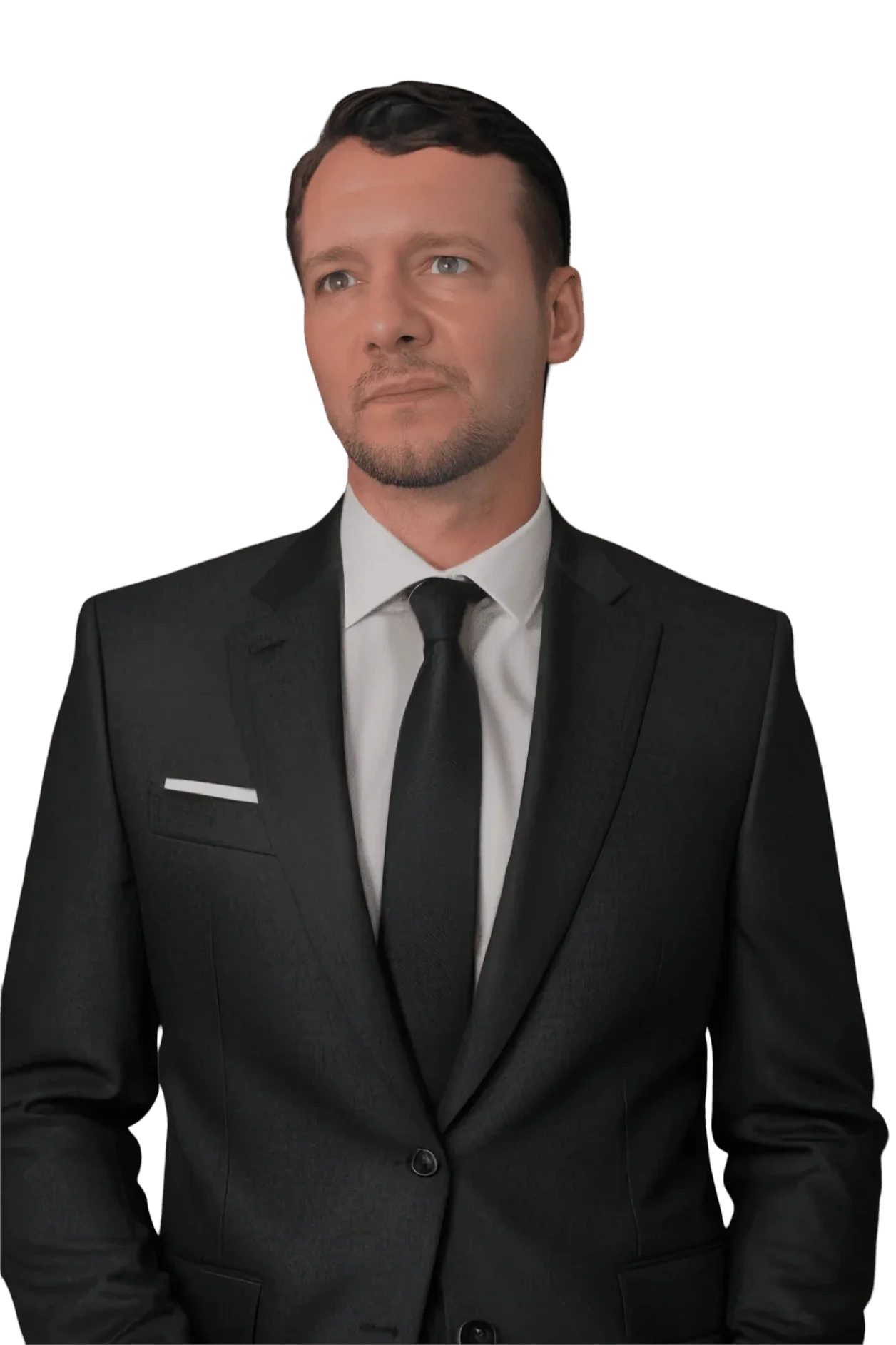 A man in a black suit, white shirt, and black tie, with short dark hair and a light beard, looking slightly to the right, against a black background.
